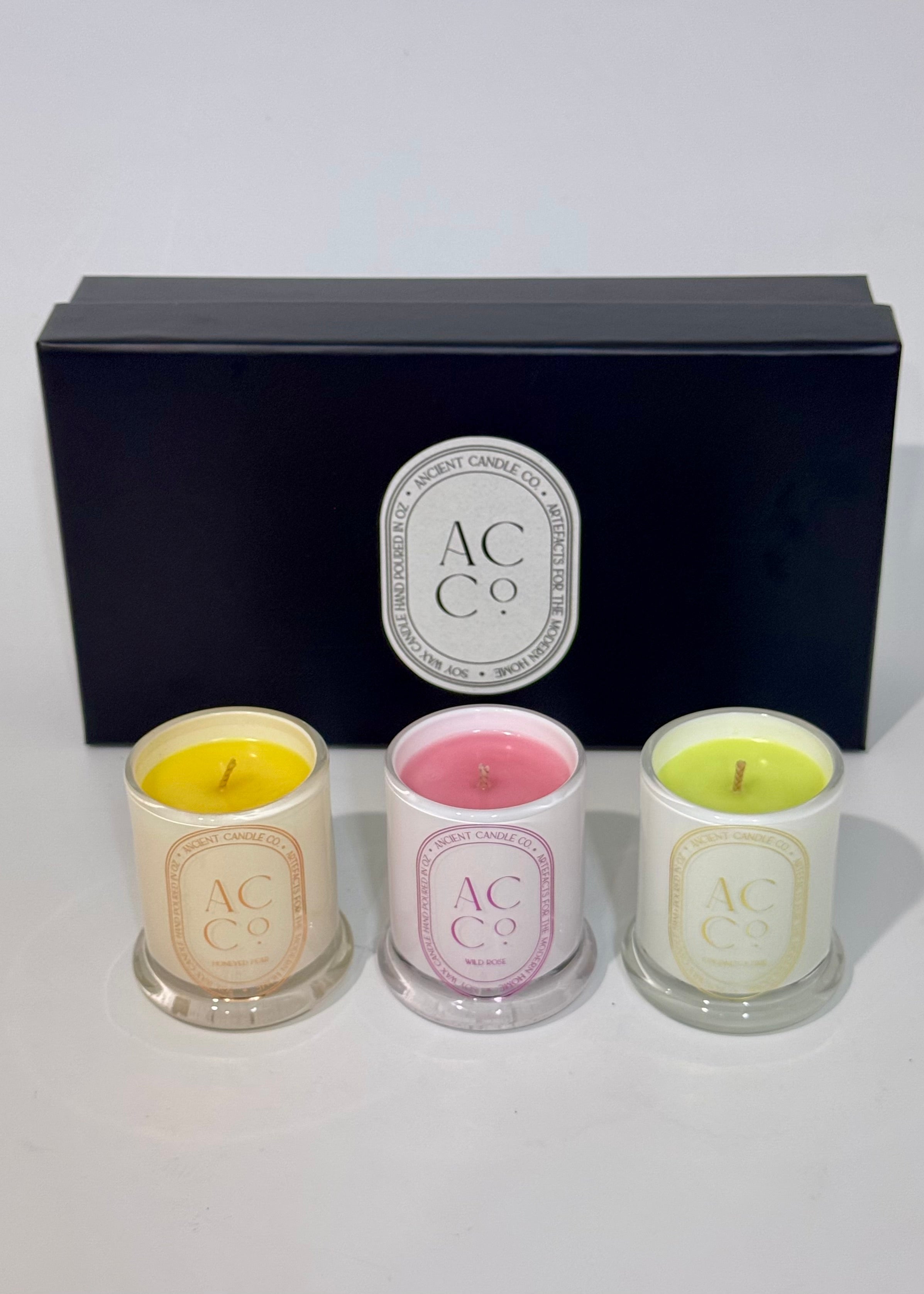 Set of three scented candles in glass containers with a black box featuring 'AC & Co.' logo on a white background.